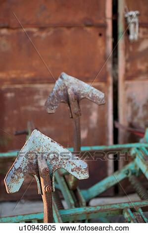 Closeup exterior view of old barn with rusty iron prongs of green harrow in foreground, old red metal doors in background, Umbria, Italy View Large Photo Image Stock Photography - Closeup exterior view of old barn with rusty iron prongs of green harrow in foreground, old red metal doors in background, Umbria, Italy. Fotosearch