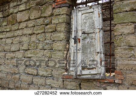 Deserted stone farmhouse in ruins, Tuscany, Italy, detail of wooden window shutter, and stone wall exterior View Large Photo Image Stock Image - Deserted stone farmhouse in ruins, Tuscany, Italy, detail of wooden window shutter, and stone wall exterior. Fotosearch