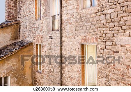 Stock Photo - Detail of stone wall of medieval palace, with multiple windows, Todi, Umbria, Italy. Fotosearch