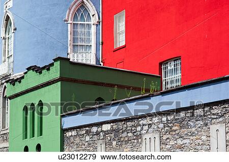 Stock Photo - Detail view of south facade of Dublin Castle, with different areas painted green, blue, red, against grey Norman stone of original fortifications, Dublin, Southern Ireland. Fotosearch