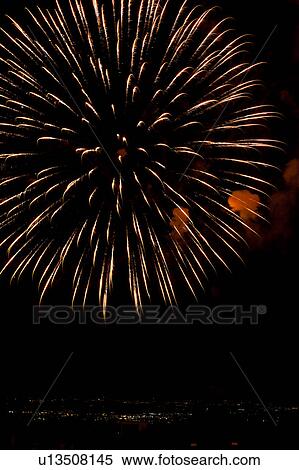 Fireworks exploding, with town lights of Umbrian valley in distance, Italy View Large Photo Image Stock Photography - Fireworks exploding, with town lights of Umbrian valley in distance, Italy. Fotosearch
