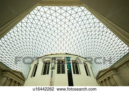 Interior of British Museum, London, England, Great Court with glass and steel ceiling covering quadrangle, with central column; modern architecture juxtaposed against classical Greek temple facades behind View Large Photo Image Stock Image - Interior of British Museum, London, England, Great Court with glass and steel ceiling covering quadrangle, with central column; modern architecture juxtaposed against classical Greek temple facades behind. Fotosearch