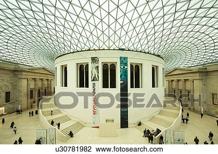 Interior of British Museum, London, England, Great Court with glass and steel ceiling covering quadrangle, central column and staircase, modern architecture juxtaposed against classical Greek temple facades behind: aerial view View Large Photo Image Stock Image - Interior of British Museum, London, England, Great Court with glass and steel ceiling covering quadrangle, central column and staircase, modern architecture juxtaposed against classical Greek temple facades behind: aerial view. Fotosearch
