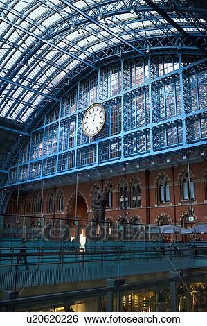 Interior of St. Pancras international railway station, London, England, showing glass and metal domed ceiling, upper concourse, with station clock, and lower shopping concourse below View Large Photo Image Stock Photograph - Interior of St. Pancras international railway station, London, England, showing glass and metal domed ceiling, upper concourse, with station clock, and lower shopping concourse below. Fotosearch