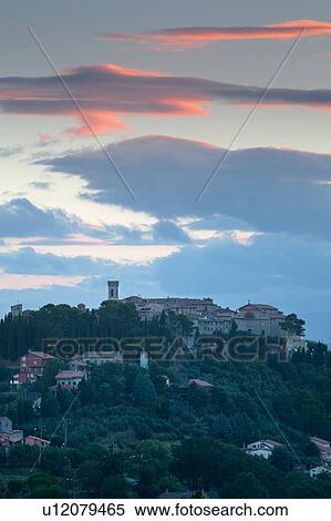 Stock Photography - Medieval hilltop town of Monte Castello di Vibio, at sunrise, with pink clouds, skyscape, Umbria, Italy. Fotosearch