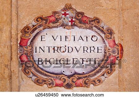 Stock Image - Notice frescoed on Renaissance palace wall in antique style, forbidding entry of bicycles, Bologna, Italy. Fotosearch