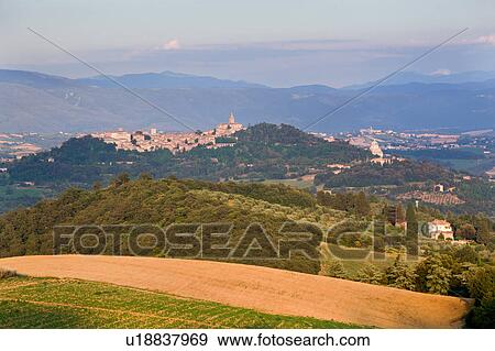 Panorama view of medieval hilltop town of Todi, at sunset, with spire of San Fortunato, and Tempio of Bramante, Umbria, Italy View Large Photo Image Stock Photo - Panorama view of medieval hilltop town of Todi, at sunset, with spire of San Fortunato, and Tempio of Bramante, Umbria, Italy. Fotosearch