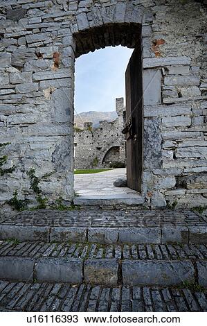 Stone steps and doorway, Castello di Vezio, Lake Como, Northern italy, showing courtyard and crenellated walls and tower on opposite side, sunlit morning in autumn. View Large Photo Image Stock Image - Stone steps and doorway, Castello di Vezio, Lake Como, Northern italy, showing courtyard and crenellated walls and tower on opposite side, sunlit morning in autumn.. Fotosearch