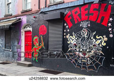 Street in Dublin with pink and purple painted walls, red wooden door and graffiti of cartoon figures amd spider web, Dublin, Southern Ireland View Large Photo Image Stock Image - Street in Dublin with pink and purple painted walls, red wooden door and graffiti of cartoon figures amd spider web, Dublin, Southern Ireland. Fotosearch