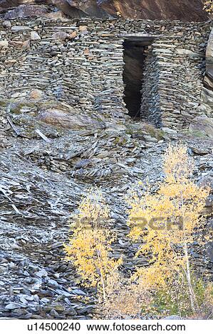 Traditional Italian crotta, storage area built of stone, into mountainside, surrounded by golden yellow foliage, autumn in Lombardy, Italy View Large Photo Image Stock Image - Traditional Italian crotta, storage area built of stone, into mountainside, surrounded by golden yellow foliage, autumn in Lombardy, Italy. Fotosearch