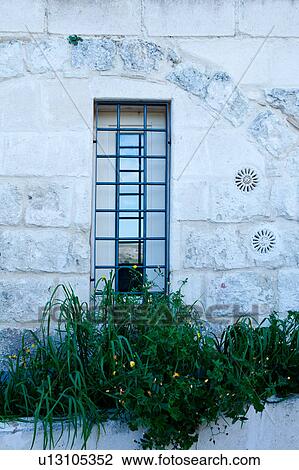 Window detail: modern window set into ancient arched frame of tufa house (Sassi) with window box of flowers in front, hills reflected in glass, Matera, sunny spring afternoon, Puglia, Southern Italy View Large Photo Image Stock Image - Window detail: modern window set into ancient arched frame of tufa house (Sassi) with window box of flowers in front, hills reflected in glass, Matera, sunny spring afternoon, Puglia, Southern Italy. Fotosearch