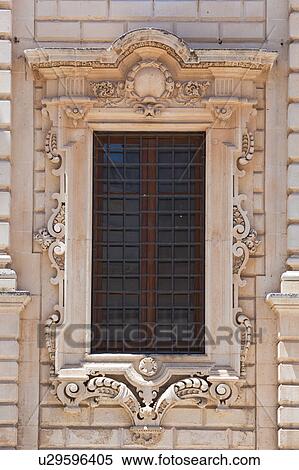 Window detail: ornate Baroque facade of Palazzo del Seminario, ornately carved in Leccese style, grid of metal bars across window, Lecce, Salento, Puglia, Southern Italy View Large Photo Image Stock Photography - Window detail: ornate Baroque facade of Palazzo del Seminario, ornately carved in Leccese style, grid of metal bars across window, Lecce, Salento, Puglia, Southern Italy. Fotosearch