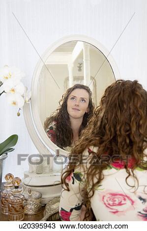 Stock Image - Beautiful young woman looking away. Fotosearch