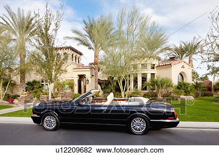 Black open roof car parked in front of mansion house View Large Photo Image Stock Image - Black open roof car parked in front of mansion house. Fotosearch