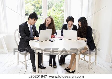 Businesspeople working on laptop View Large Photo Image Stock Photo - Businesspeople working on laptop. Fotosearch