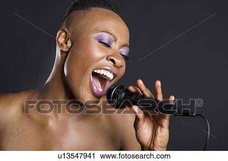 Stock Image - Close-up of African American woman singing. Fotosearch