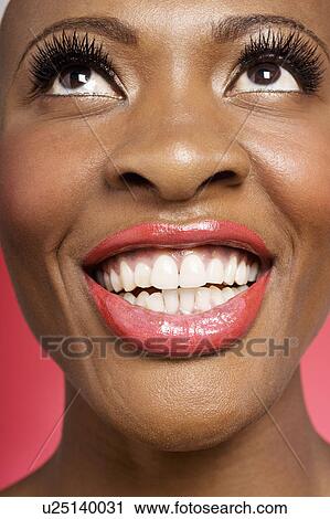 Close up of cheerful woman looking up View Large Photo Image Stock Image - Close up of cheerful woman looking up. Fotosearch
