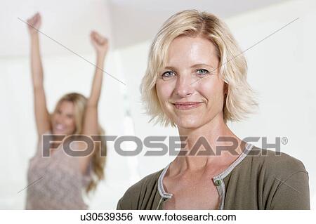 Close up of mother with excited daughter raising hands View Large Photo Image Stock Photograph - Close up of mother with excited daughter raising hands. Fotosearch