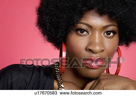 Stock Image - Close up of young curly haired woman. Fotosearch