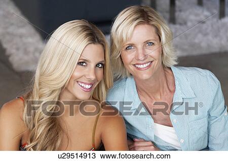 Stock Image - Close-up portrait of mother and daughter. Fotosearch