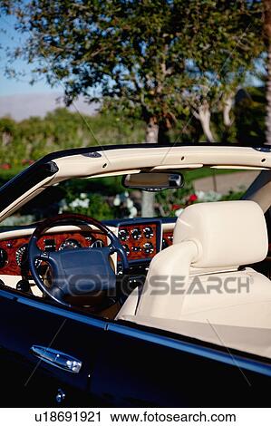 Stock Image - Close-up view steering wheel of open roof car. Fotosearch
