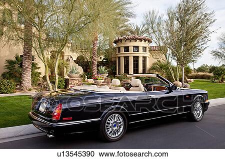 Convertible car parked outside mansion house View Large Photo Image Stock Image - Convertible car parked outside mansion house. Fotosearch