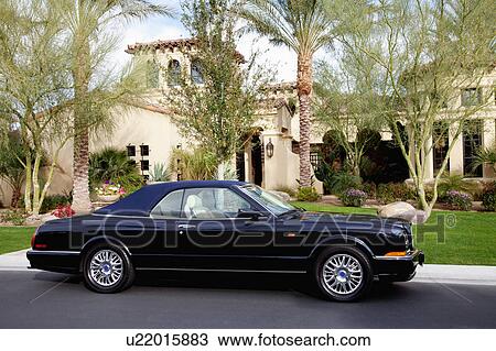 Convertible car standing outside of a luxury house View Large Photo Image Stock Image - Convertible car standing outside of a luxury house. Fotosearch