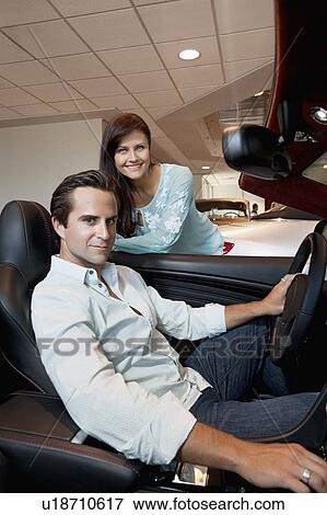 Couple buying a new car View Large Photo Image Stock Photo - Couple buying a new car. Fotosearch