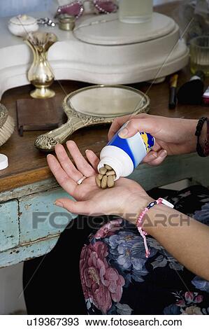 Cropped image of woman taking medicine View Large Photo Image Stock Image - Cropped image of woman taking medicine. Fotosearch