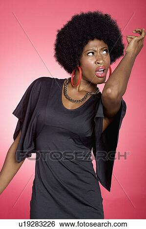 Dancing young woman over colored background View Large Photo Image Stock Photograph - Dancing young woman over colored background. Fotosearch