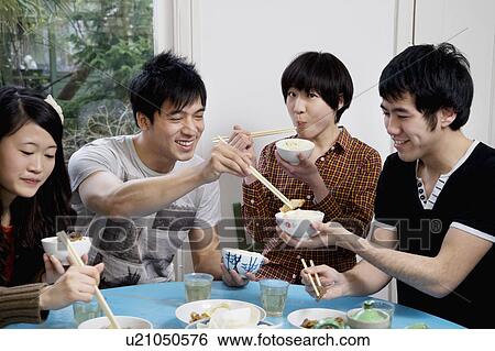 Stock Photograph - Friends enjoying breakfast together. Fotosearch