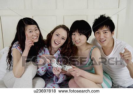 Friends playing video game View Large Photo Image Stock Photo - Friends playing video game. Fotosearch
