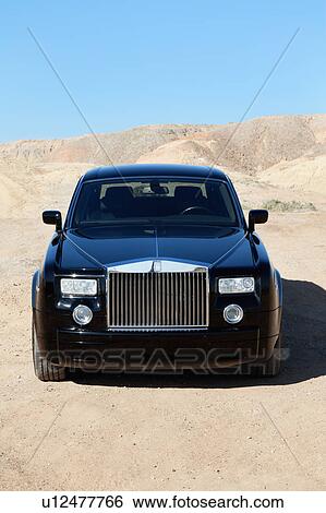 Front view of Rolls Royce parked on unpaved road View Large Photo Image Stock Photograph - Front view of Rolls Royce parked on unpaved road. Fotosearch