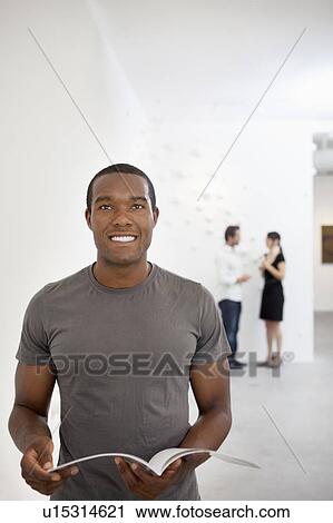 Stock Image - Front view of young man in casual looking up. Fotosearch