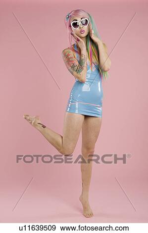 Full length of a woman posing against white background View Large Photo Image Stock Photo - Full length of a woman posing against white background. Fotosearch