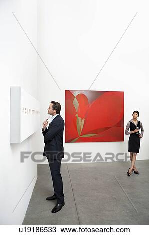 Full length of man standing in front of wall painting and woman View Large Photo Image Stock Image - Full length of man standing in front of wall painting and woman. Fotosearch