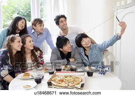Group of friends taking self portrait photograph View Large Photo Image Stock Image - Group of friends taking self portrait photograph. Fotosearch