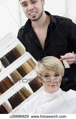 Hairdresser suggesting hair shades to customer View Large Photo Image Stock Photo - Hairdresser suggesting hair shades to customer. Fotosearch