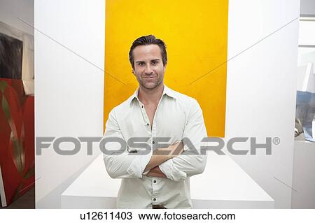 Half-length portrait of smiling young man in front of yellow painting View Large Photo Image Stock Image - Half-length portrait of smiling young man in front of yellow painting. Fotosearch