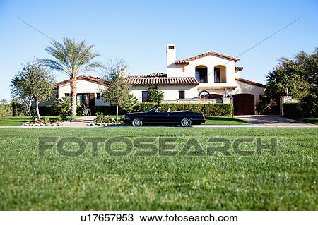 Luxurious car parked outside house in front yard View Large Photo Image Stock Image - Luxurious car parked outside house in front yard. Fotosearch