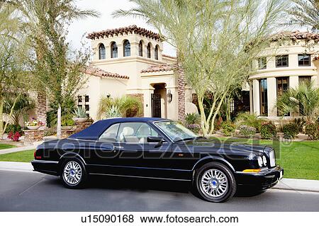 Luxurious convertible car parked in front of a villa View Large Photo Image Stock Photo - Luxurious convertible car parked in front of a villa. Fotosearch