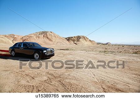 Stock Photography - Luxurious Rolls Royce car emitting pollution. Fotosearch