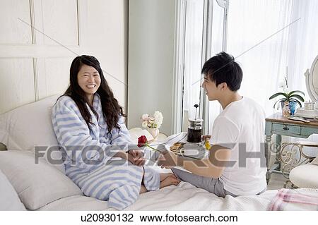 Man giving rose to woman in bed View Large Photo Image Stock Image - Man giving rose to woman in bed. Fotosearch