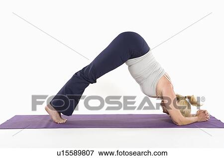 Stock Photo - Mature woman doing an expert yoga exercise. Fotosearch