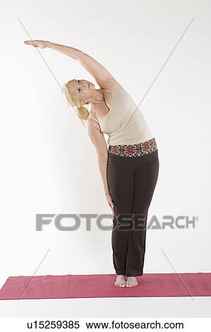 Stock Photography - Mature woman doing stretching exercise. Fotosearch