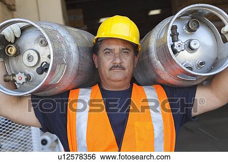 Portrait of a middle-aged man carrying cylinder View Large Photo Image Stock Photograph - Portrait of a middle-aged man carrying cylinder. Fotosearch