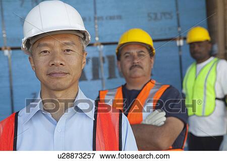 Portrait of a smiling middle-aged man with colleagues View Large Photo Image Stock Photo - Portrait of a smiling middle-aged man with colleagues. Fotosearch