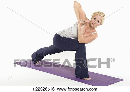 Stock Photograph - Portrait of mature woman doing yoga. Fotosearch