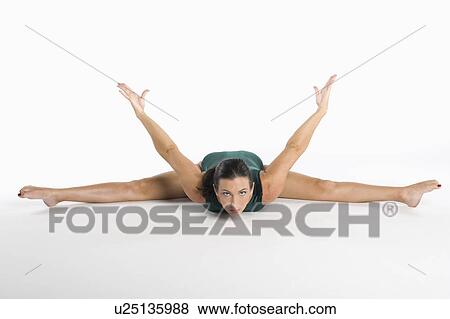 Portrait of mid adult woman exercising over white background View Large Photo Image Stock Photo - Portrait of mid adult woman exercising over white background. Fotosearch