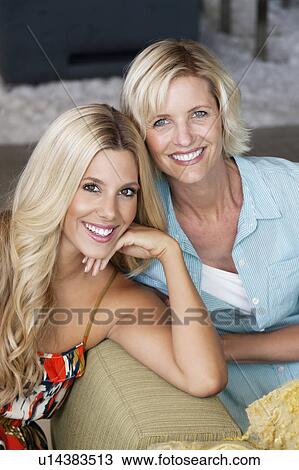 Stock Image - Portrait of mother and daughter at home. Fotosearch